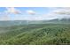 Breathtaking shot of rolling hills covered with trees and the sky above is filled with wispy clouds at 521 East Valley Ne Rd, Rydal, GA 30171