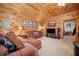 Wood paneled living room featuring comfortable seating and natural light at 521 East Valley Ne Rd, Rydal, GA 30171