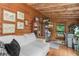 Cozy living room features log walls, hardwood floors, and a comfortable white sofa at 521 East Valley Ne Rd, Rydal, GA 30171