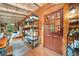 Home office featuring wood-paneled walls and ceiling and a view into an adjacent living space at 521 East Valley Ne Rd, Rydal, GA 30171
