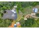Expansive Palmetto, GA property featuring a home, pond, RV shed, and shed, all surrounded by lush greenery at 6160 Campbellton Redwine Rd, Chattahoochee Hills, GA 30268