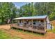 Charming exterior view with a porch, featuring a rustic design and a welcoming entrance at 6160 Campbellton Redwine Rd, Chattahoochee Hills, GA 30268