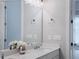 Bathroom vanity with white countertop, sink, chrome faucet, and decorative vase in mirror at 992 Harvest Park Ln, Suwanee, GA 30024