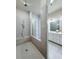 Bathroom featuring an open shower with modern tile, a built-in seat, and dual sink vanity at 992 Harvest Park Ln, Suwanee, GA 30024