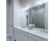 Bathroom features a dual sink vanity with white countertops and a large mirror at 992 Harvest Park Ln, Suwanee, GA 30024