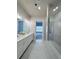 Bathroom showcases a dual sink vanity with white countertops and an adjacent shower room at 992 Harvest Park Ln, Suwanee, GA 30024
