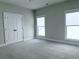 Spacious bedroom features neutral carpet, light gray walls, and modern double door closet at 992 Harvest Park Ln, Suwanee, GA 30024