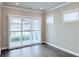 Cozy bedroom with sliding glass doors to a patio and a large window allowing natural light at 992 Harvest Park Ln, Suwanee, GA 30024