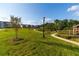 Scenic view of the community park with walking paths, a vintage lamppost, and modern homes in the background at 992 Harvest Park Ln, Suwanee, GA 30024