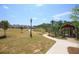 Expansive community park featuring manicured lawns, walking paths, and decorative lampposts on a bright sunny day at 992 Harvest Park Ln, Suwanee, GA 30024