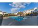 Community pool with lounge chairs and covered patio overlooking neighborhood homes and cloudy skies at 992 Harvest Park Ln, Suwanee, GA 30024