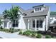 Charming two-story home featuring white siding, a covered front porch, and professionally landscaped yard at 992 Harvest Park Ln, Suwanee, GA 30024