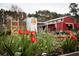 Farm featuring tulip garden in front of white water tower and barn at 992 Harvest Park Ln, Suwanee, GA 30024