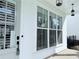 Close up of the front porch with large windows, a secure door, and modern hanging lights at 992 Harvest Park Ln, Suwanee, GA 30024