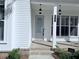 View of the front door and porch with brick and hanging lights at 992 Harvest Park Ln, Suwanee, GA 30024