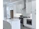 Bright kitchen features white cabinets, stainless steel appliances, and a center island with a sink at 992 Harvest Park Ln, Suwanee, GA 30024