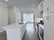 Modern kitchen with stainless steel appliances, a large island, and sleek countertops at 992 Harvest Park Ln, Suwanee, GA 30024