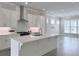Open concept kitchen with a large island, stainless steel appliances, and adjacent living area at 992 Harvest Park Ln, Suwanee, GA 30024