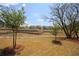 Landscape featuring terraced backyard and dry creek bed with neighborhood homes in the distance at 992 Harvest Park Ln, Suwanee, GA 30024