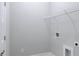 Bright laundry room features storage shelf, electrical outlets, and white walls at 992 Harvest Park Ln, Suwanee, GA 30024