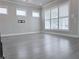 Bright living room with hardwood flooring, large windows with shutters and modern chandelier at 992 Harvest Park Ln, Suwanee, GA 30024