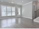 Light-filled living room with hardwood floors and a view to the landscaped front yard at 992 Harvest Park Ln, Suwanee, GA 30024