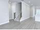 Open living area with hardwood floors and staircase leading upstairs at 992 Harvest Park Ln, Suwanee, GA 30024