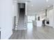 Open-concept living space with hardwood floors, a staircase, and a modern kitchen area at 992 Harvest Park Ln, Suwanee, GA 30024