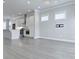 Spacious living room featuring hardwood floors, recessed lighting, and an adjacent kitchen at 992 Harvest Park Ln, Suwanee, GA 30024