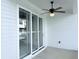 Covered patio featuring white siding, ceiling fan and sliding glass doors leading to indoor space at 992 Harvest Park Ln, Suwanee, GA 30024