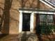 Front entrance features a black door with sidelight, brick facade, and small garden at 2566 Stratford Ln, Morrow, GA 30260