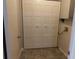 Spacious laundry room featuring a large closet with bi-fold doors and tile floor at 2566 Stratford Ln, Morrow, GA 30260