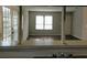 Living room area featuring wood flooring and a window, viewed from kitchen at 2566 Stratford Ln, Morrow, GA 30260