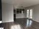 Bright living room with laminate wood flooring, view into kitchen and patio doors at 2566 Stratford Ln, Morrow, GA 30260