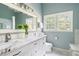 Bright bathroom features a double vanity with marble countertop and stylish fixtures at 2915 Preakness Nw Dr, Marietta, GA 30064