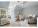 Bright Bedroom featuring a crib, comfortable glider, plush rug, and themed décor at 2915 Preakness Nw Dr, Marietta, GA 30064