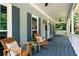 Inviting front porch with comfortable seating and blue painted floor at 2915 Preakness Nw Dr, Marietta, GA 30064