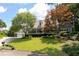 Beautiful home with a lush green lawn, mature trees, and a charming covered porch at 2915 Preakness Nw Dr, Marietta, GA 30064