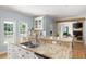The kitchen island features granite countertops and stainless steel sink, with a view of the living area and bright windows at 2915 Preakness Nw Dr, Marietta, GA 30064