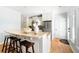Kitchen island with granite countertops, seating, and stainless steel refrigerator provides a central gathering spot at 2915 Preakness Nw Dr, Marietta, GA 30064