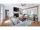 Open floor plan featuring living room, a fireplace, modern ceiling fan, with a view into the adjoining living space at 2915 Preakness Nw Dr, Marietta, GA 30064