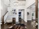 Grand two-story entry foyer featuring beautiful hardwood floors, a decorative fireplace, and a statement chandelier at 327 6Th Ne St, Atlanta, GA 30308