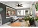 Inviting covered porch with comfortable seating, a ceiling fan, stylish decor, and a vibrant area rug at 327 6Th Ne St, Atlanta, GA 30308