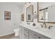 Elegant bathroom featuring double sinks, modern fixtures, and decorative mirrors at 833 Society Ct, Woodstock, GA 30188