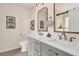 Stylish bathroom with double sinks, modern fixtures, and framed mirrors at 833 Society Ct, Woodstock, GA 30188