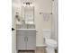 A half bath with gray vanity with modern faucet and fixtures at 833 Society Ct, Woodstock, GA 30188
