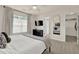 Relaxing bedroom features a ceiling fan, TV, and a walk-in closet for ample storage at 833 Society Ct, Woodstock, GA 30188