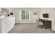 A neutral bedroom features a closet, large window, and neutral carpet at 833 Society Ct, Woodstock, GA 30188