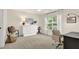 A neutral bedroom features a closet, large window, and neutral carpet at 833 Society Ct, Woodstock, GA 30188