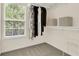 An organized closet provides great storage with natural light and hanging storage at 833 Society Ct, Woodstock, GA 30188